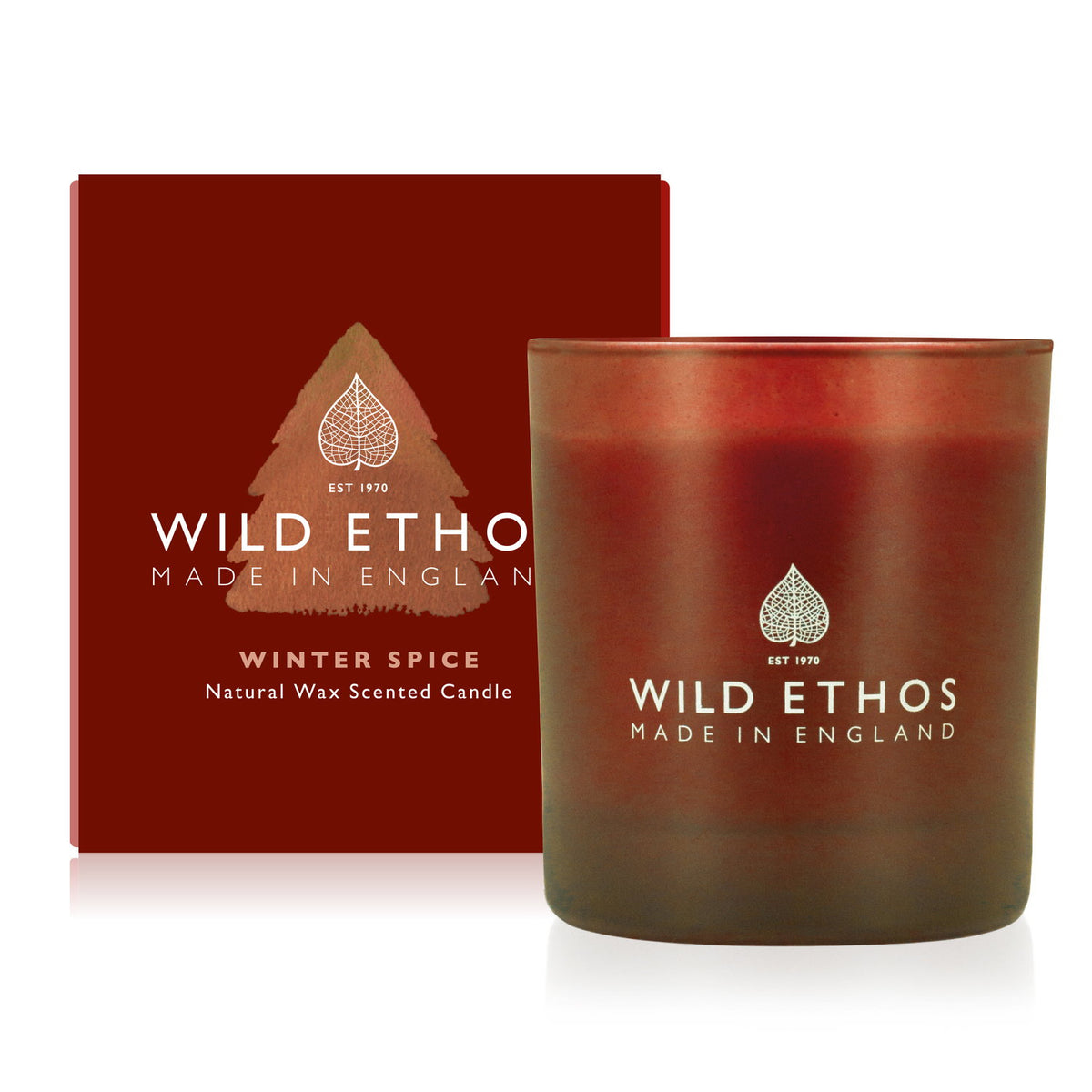 Wild Ethos Winter Spice scented candle in a red frosted glass jar beside its red gift box