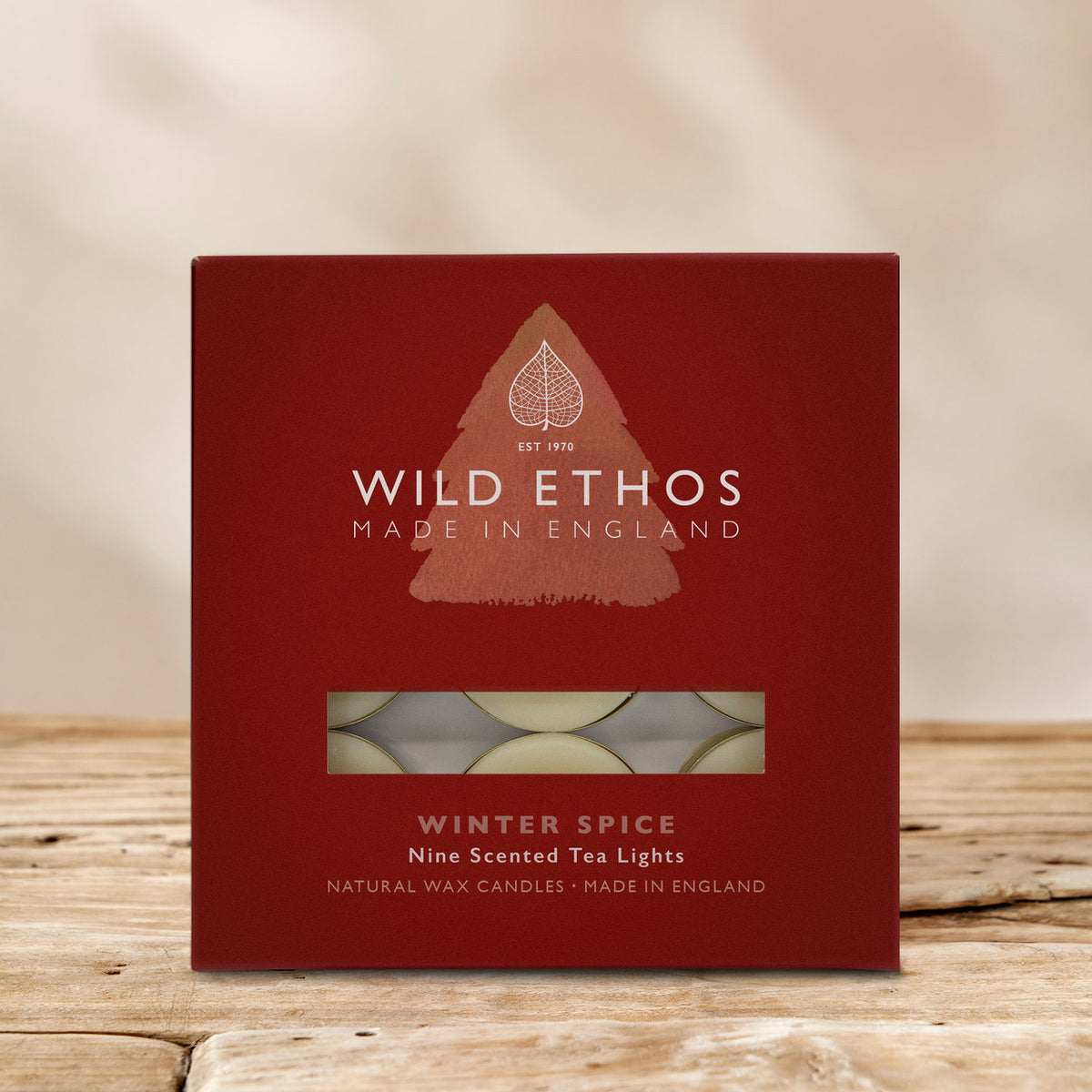 Wild Ethos Winter Spice nine scented tea lights in a red gift box with a window showing the natural wax candles